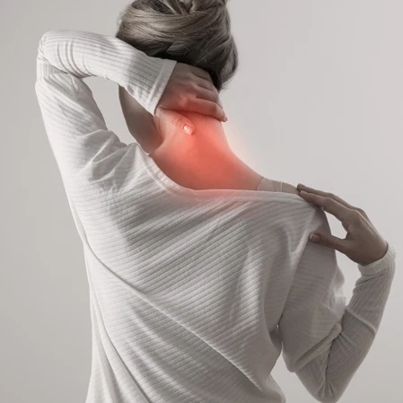 A person holding their neck. Their neck is highlighted red.